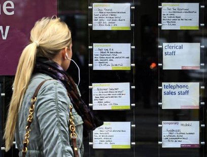 A woman passes notices for jobs in the window of a recruitment agency in London April 13, 2011. REUTERS/Luke MacGregor A woman passes notices for jobs in the window of a recruitment agency in London April 13, 2011. REUTERS/Luke MacGregor