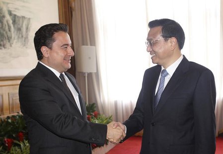 China's Premier Li Keqiang shakes hands with Turkey's Deputy Prime Minister Ali Babacan (L) during the Annual Meeting of the New Champions, China's Premier Li Keqiang shakes hands with Turkey's Deputy Prime Minister Ali Babacan (L) during the Annual Meeting of the New Champions,