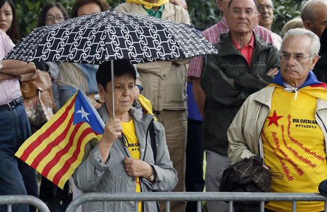 A woman holds an "Estelada" (Catalonia separatist flag) flag as she attends a ceremony to mark the "Diada de Catalunya" (Catalunya's Nationa A woman holds an "Estelada" (Catalonia separatist flag) flag as she attends a ceremony to mark the "Diada de Catalunya" (Catalunya's Nationa