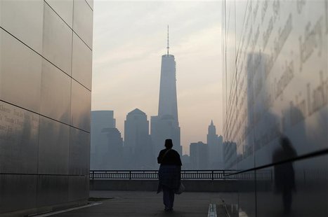 A woman looks out at New York's Lower Manhattan and One World Trade Center from inside the 9/11 Empty Sky memorial at Liberty State Park in A woman looks out at New York's Lower Manhattan and One World Trade Center from inside the 9/11 Empty Sky memorial at Liberty State Park in