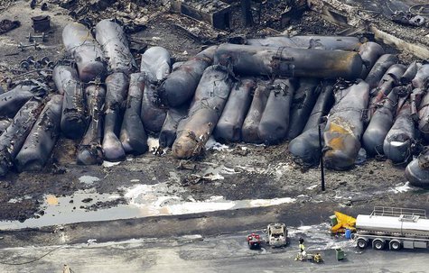 A firefighter stands close to the remains of a train wreckage in Lac Megantic July 8, 2013. REUTERS/Mathieu Belanger A firefighter stands close to the remains of a train wreckage in Lac Megantic July 8, 2013. REUTERS/Mathieu Belanger
