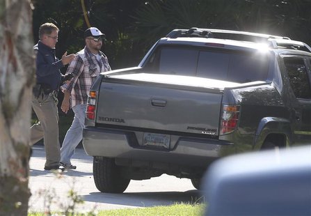 Geroge Zimmerman (R) walks toward his vehicle before entering a house that he and his wife Shellie Zimmerman were renting in Lake Mary, Flor Geroge Zimmerman (R) walks toward his vehicle before entering a house that he and his wife Shellie Zimmerman were renting in Lake Mary, Flor