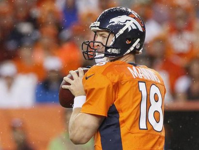 Denver Broncos quarterback Peyton Manning looks to pass against the Baltimore Ravens during their NFL football game in Denver, Colorado Sept Denver Broncos quarterback Peyton Manning looks to pass against the Baltimore Ravens during their NFL football game in Denver, Colorado Sept