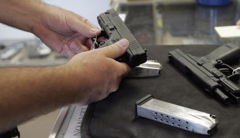 A customer inspects a 9mm handgun at Rink's Gun and Sport in the Chicago, suburb of Lockport, Illinois in this June 26, 2008 file photograph A customer inspects a 9mm handgun at Rink's Gun and Sport in the Chicago, suburb of Lockport, Illinois in this June 26, 2008 file photograph