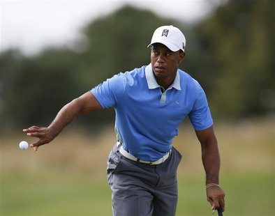 Tiger Woods of the U.S. tosses his ball to his caddy during the Pro-Am round of the BMW Championship golf tournament at the Conway Farms Gol Tiger Woods of the U.S. tosses his ball to his caddy during the Pro-Am round of the BMW Championship golf tournament at the Conway Farms Gol
