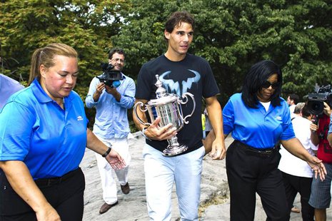 Rafael Nadal (C) of Spain arrives with his trophy for a photo call after winning the men's singles final match against Novak Djokovic of Ser Rafael Nadal (C) of Spain arrives with his trophy for a photo call after winning the men's singles final match against Novak Djokovic of Ser
