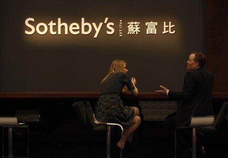 Staff members chat during Sotheby's preview in Hong Kong April 2, 2013. REUTERS/Bobby Yip Staff members chat during Sotheby's preview in Hong Kong April 2, 2013. REUTERS/Bobby Yip
