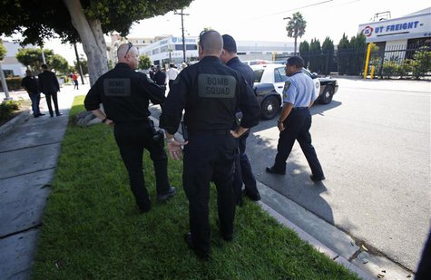 Sheriff's Department Bomb Squad officers and other officers are pictured in the vicinity of the apartment complex of suspect Nna Alpha Onuoh Sheriff's Department Bomb Squad officers and other officers are pictured in the vicinity of the apartment complex of suspect Nna Alpha Onuoh
