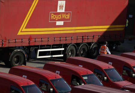 A Royal Mail postal worker walks through the car park of a sorting ofice in Altrincham, northern England July 10, 2013. REUTERS/Phil Noble A Royal Mail postal worker walks through the car park of a sorting ofice in Altrincham, northern England July 10, 2013. REUTERS/Phil Noble