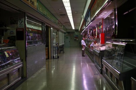 A man shops at a butcher's store in a local market in Madrid September 4, 2012. REUTERS/Susana Vera A man shops at a butcher's store in a local market in Madrid September 4, 2012. REUTERS/Susana Vera