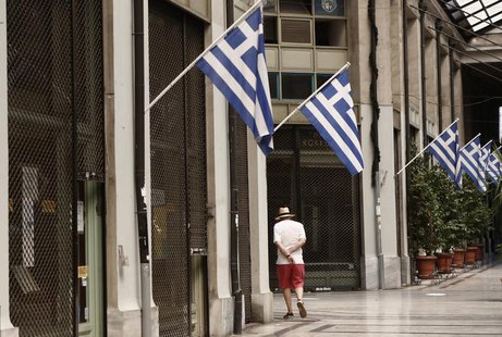 A man walks by a row of closed shops at an arcade in central Athens August 26, 2013. REUTERS/John Kolesidis A man walks by a row of closed shops at an arcade in central Athens August 26, 2013. REUTERS/John Kolesidis