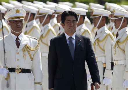 Japan's Prime Minister Shinzo Abe reviews the honour guard before a meeting with Japan Self-Defense Force's senior members at the Defense Mi Japan's Prime Minister Shinzo Abe reviews the honour guard before a meeting with Japan Self-Defense Force's senior members at the Defense Mi