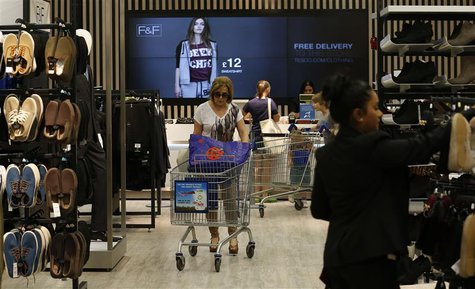 Customers shop in the F&F clothing department at a Tesco Extra supermarket in Watford, north of London August 8, 2013. REUTERS/Suzanne Plunk Customers shop in the F&F clothing department at a Tesco Extra supermarket in Watford, north of London August 8, 2013. REUTERS/Suzanne Plunk