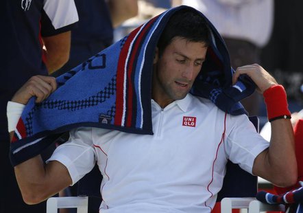 Novak Djokovic of Serbia pauses during a break in play against Stanislas Wawrinka of Switzerland during their men's semi-final match at the Novak Djokovic of Serbia pauses during a break in play against Stanislas Wawrinka of Switzerland during their men's semi-final match at the