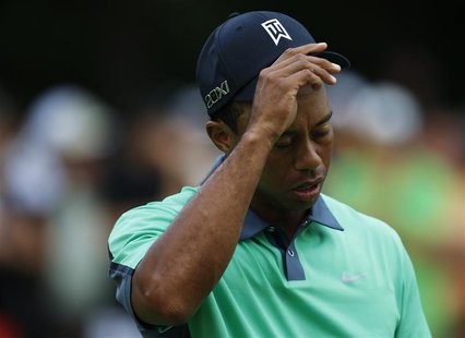 Tiger Woods of the U.S. walks off the course after finishing the first round of the BMW Championship golf tournament at the Conway Farms Gol Tiger Woods of the U.S. walks off the course after finishing the first round of the BMW Championship golf tournament at the Conway Farms Gol
