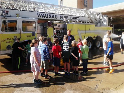 Wausau Montessori students get a lesson in fire truck cleaning at Wausau Fire Department, September 11 2013 Wausau Montessori students get a lesson in fire truck cleaning at Wausau Fire Department, September 11 2013