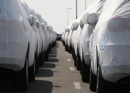 New cars of several brands of German carmaker Volkswagen AG are covered with protective covers before they are loaded for export on a transp New cars of several brands of German carmaker Volkswagen AG are covered with protective covers before they are loaded for export on a transp