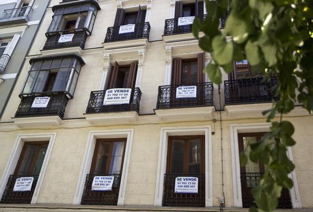 Signs saying "For Sale" hang on the balconies of an apartment block in central Madrid, June 14, 2012. REUTERS/Paul Hanna Signs saying "For Sale" hang on the balconies of an apartment block in central Madrid, June 14, 2012. REUTERS/Paul Hanna