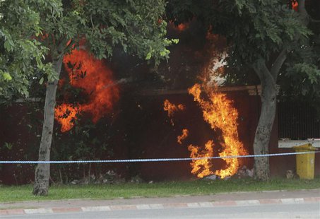 Flames erupt as a bomb, which was discovered outside of Cambodia's National Assembly, is detonated by Cambodian Mine Action Center (CMAC) pe Flames erupt as a bomb, which was discovered outside of Cambodia's National Assembly, is detonated by Cambodian Mine Action Center (CMAC) pe