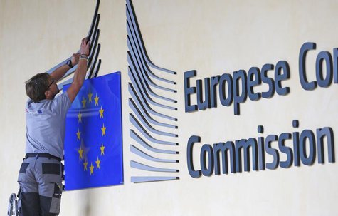 A worker adjusts and cleans the logo of the European Commission at the entrance of the Berlaymont building, the EC headquarters, in Brussels A worker adjusts and cleans the logo of the European Commission at the entrance of the Berlaymont building, the EC headquarters, in Brussels