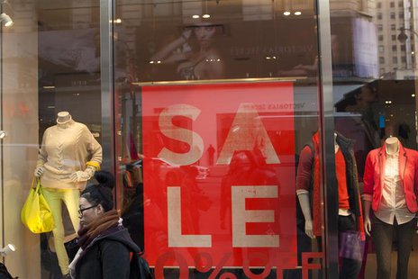 People walk in front of a store advertising sales in New York, December 24, 2012. REUTERS/Keith Bedford People walk in front of a store advertising sales in New York, December 24, 2012. REUTERS/Keith Bedford