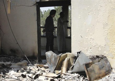 Men inspect a house damaged during assaults on militant targets by the Egyptian Army, in a village on the outskirts of Sheikh Zuweid, near t Men inspect a house damaged during assaults on militant targets by the Egyptian Army, in a village on the outskirts of Sheikh Zuweid, near t