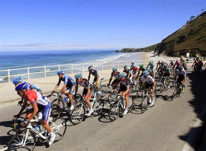 Cyclists ride near the sea during the 181-km 19th stage of the Vuelta, Tour of Spain cycling race from San Vicente de la Barquera to Alto de Cyclists ride near the sea during the 181-km 19th stage of the Vuelta, Tour of Spain cycling race from San Vicente de la Barquera to Alto de