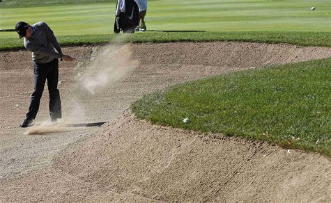 Rory McIlroy of Northern Ireland hits out of the sand trap the first hole during the second round of the BMW Championship golf tournament at Rory McIlroy of Northern Ireland hits out of the sand trap the first hole during the second round of the BMW Championship golf tournament at