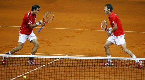 Canada's Vasek Pospisil (L) and Daniel Nestor celebrate a point against Serbia's Nenad Zimonjic and Ilija Bozoljac during their Davis Cup se Canada's Vasek Pospisil (L) and Daniel Nestor celebrate a point against Serbia's Nenad Zimonjic and Ilija Bozoljac during their Davis Cup se