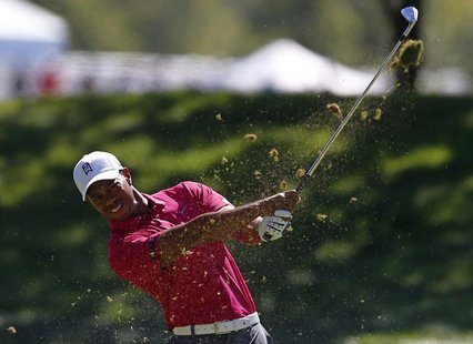 Tiger Woods of the U.S. watches his approach shot on the first hole during the third round of the BMW Championship golf tournament at the Co Tiger Woods of the U.S. watches his approach shot on the first hole during the third round of the BMW Championship golf tournament at the Co