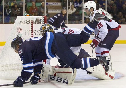 Winnipeg Jets Evander Kane (L) is tripped up by Washington Capitals goalie Branden Holtby in the first period of their NHL pre-season hockey Winnipeg Jets Evander Kane (L) is tripped up by Washington Capitals goalie Branden Holtby in the first period of their NHL pre-season hockey