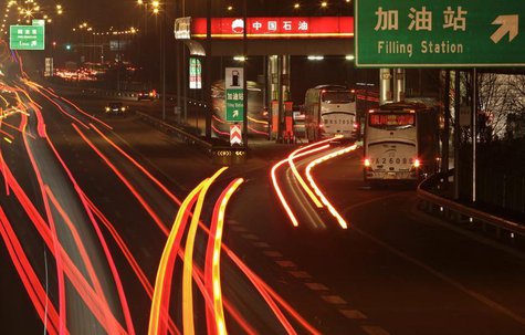 Cars drive into a Petrol China gas station, as other vehicles drive past on the Beijing-Tibet expressway in Beijing, March 23, 2012. CREUTER Cars drive into a Petrol China gas station, as other vehicles drive past on the Beijing-Tibet expressway in Beijing, March 23, 2012. CREUTER