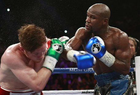 WBC/WBA 154-pound champion Canelo Alvarez (L) takes a punch from Floyd Mayweather Jr. of the U.S. at the MGM Grand Garden Arena in Las Vegas WBC/WBA 154-pound champion Canelo Alvarez (L) takes a punch from Floyd Mayweather Jr. of the U.S. at the MGM Grand Garden Arena in Las Vegas