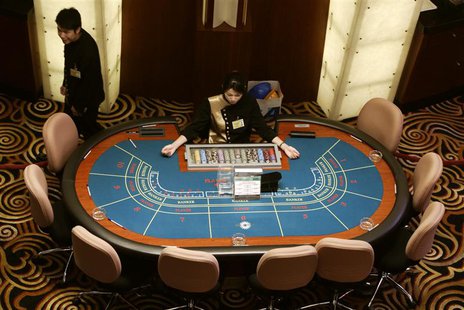 A high angle view of croupiers preparing to greet visitors at Sands Macau casino in Macau, a former Portuguese enclave before reverting to C A high angle view of croupiers preparing to greet visitors at Sands Macau casino in Macau, a former Portuguese enclave before reverting to C