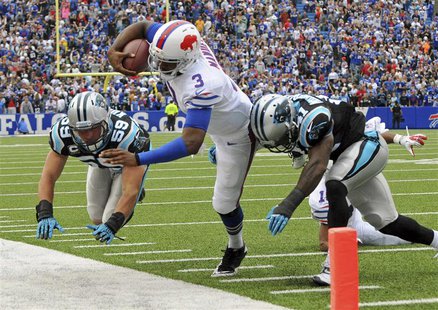Buffalo Bills quarterback EJ Manuel (C) is knocked out of bounds by Carolina Panthers cornerback Captain Munnerlyn (R) and linebacker Luke K Buffalo Bills quarterback EJ Manuel (C) is knocked out of bounds by Carolina Panthers cornerback Captain Munnerlyn (R) and linebacker Luke K