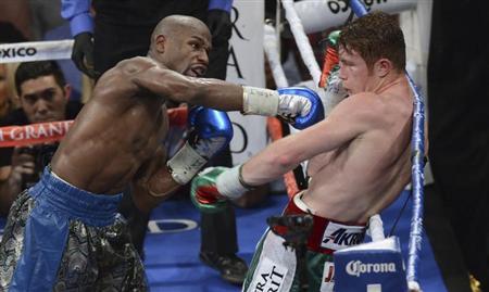 Floyd Mayweather Jr. (L) of the U.S. punches on WBC/WBA 154-pound champion Canelo Alvarez of Mexico during their title fight at the MGM Grand Garden Arena in Las Vegas, Nevada, September 14, 2013.
Credit: REUTERS/Mark Hundley Floyd Mayweather Jr. (L) of the U.S. punches on WBC/WBA 154-pound champion Canelo Alvarez of Mexico during their title fight at the MGM Grand Garden Arena in Las Vegas, Nevada, September 14, 2013.
Credit: REUTERS/Mark Hundley