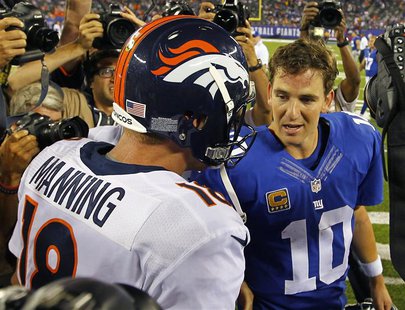 Denver Broncos quarterback Peyton Manning (L) talks with his brother, New York Giants quarterback Eli Manning after the Broncos defeated the Denver Broncos quarterback Peyton Manning (L) talks with his brother, New York Giants quarterback Eli Manning after the Broncos defeated the