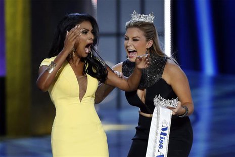 Miss America contestant, Miss New York Nina Davuluri (L) reacts with 2013 Miss America Mallory Hagan after being chosen winner of the 2014 M Miss America contestant, Miss New York Nina Davuluri (L) reacts with 2013 Miss America Mallory Hagan after being chosen winner of the 2014 M