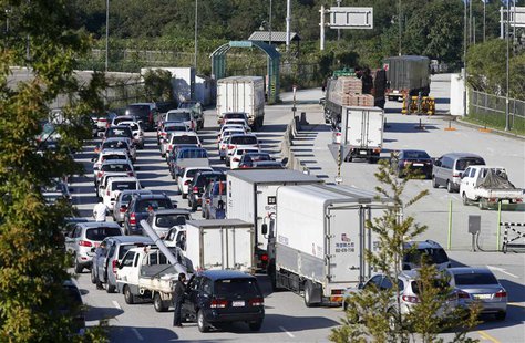South Korean businessmen and workers in their vehicles leave the customs, immigration and quarantine office area, just south of the demilita South Korean businessmen and workers in their vehicles leave the customs, immigration and quarantine office area, just south of the demilita