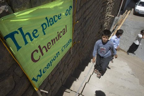 A boy walks past a placard which shows the place of an Iraqi chemical attack during the 1980-1988 war against Iran, in Nowdesheh in Kermansh A boy walks past a placard which shows the place of an Iraqi chemical attack during the 1980-1988 war against Iran, in Nowdesheh in Kermansh