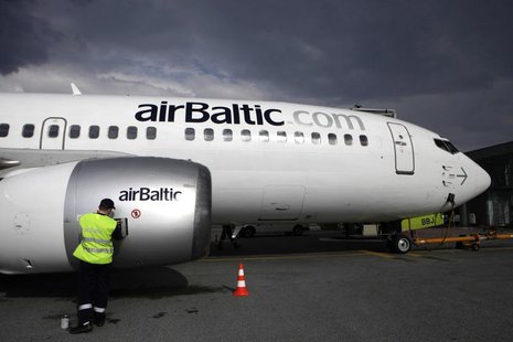 A worker services an airBaltic plane in Riga airport May 13, 2010. REUTERS/Ints Kalnins A worker services an airBaltic plane in Riga airport May 13, 2010. REUTERS/Ints Kalnins