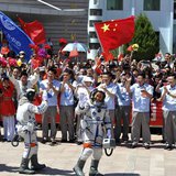Chinese astronauts (from L to R) Wang Yaping, Zhang Xiaoguang and Nie Haisheng wave before leaving for the Shenzhou-10 manned spacecraft mis Chinese astronauts (from L to R) Wang Yaping, Zhang Xiaoguang and Nie Haisheng wave before leaving for the Shenzhou-10 manned spacecraft mis