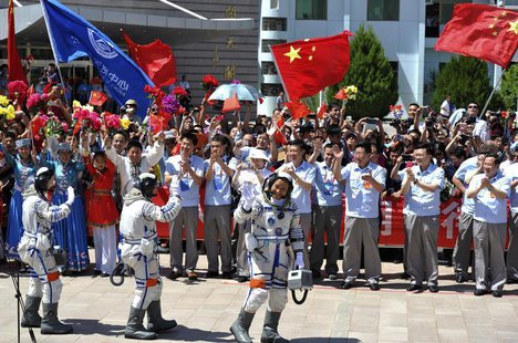 Chinese astronauts (from L to R) Wang Yaping, Zhang Xiaoguang and Nie Haisheng wave before leaving for the Shenzhou-10 manned spacecraft mis Chinese astronauts (from L to R) Wang Yaping, Zhang Xiaoguang and Nie Haisheng wave before leaving for the Shenzhou-10 manned spacecraft mis