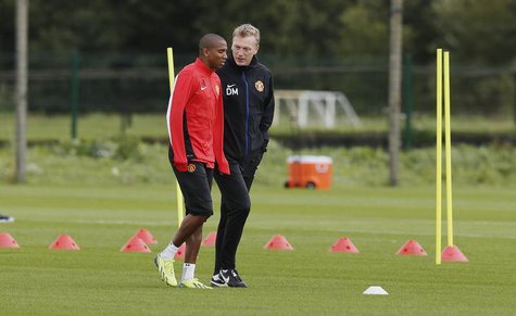 Manchester United's manager David Moyes (R) talks with player Ashley Young during a soccer training session at the club's Carrington trainin Manchester United's manager David Moyes (R) talks with player Ashley Young during a soccer training session at the club's Carrington trainin