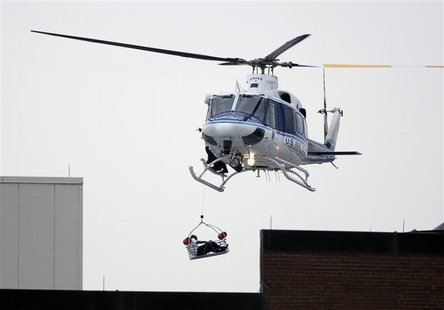 A helicopter pulls up an apparent shooting victim as it hovers over a rooftop on the Washington Navy Yard campus in Washington, September 16 A helicopter pulls up an apparent shooting victim as it hovers over a rooftop on the Washington Navy Yard campus in Washington, September 16