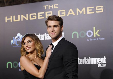 Cast member Liam Hemsworth poses with actress Miley Cyrus at the premiere of "The Hunger Games" at Nokia theatre in Los Angeles, California Cast member Liam Hemsworth poses with actress Miley Cyrus at the premiere of "The Hunger Games" at Nokia theatre in Los Angeles, California