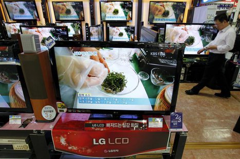 An employee of an electronics shop works behind an LG Electronics' LCD television set (front) in Seoul April 27, 2011. REUTERS/Jo Yong-Hak An employee of an electronics shop works behind an LG Electronics' LCD television set (front) in Seoul April 27, 2011. REUTERS/Jo Yong-Hak