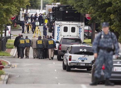 Police walk in the Washington Navy Yard after a shooting in Washington on September 16, 2013. REUTERS/Joshua Roberts Police walk in the Washington Navy Yard after a shooting in Washington on September 16, 2013. REUTERS/Joshua Roberts