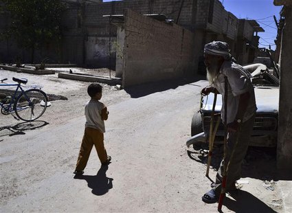 Abou Al Eizz Al-Saour, stands along a street in the Duma neighbourhood of Damascus September 16, 2013. Al-Saour, 55, was wounded from a rock Abou Al Eizz Al-Saour, stands along a street in the Duma neighbourhood of Damascus September 16, 2013. Al-Saour, 55, was wounded from a rock
