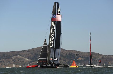 Oracle Team USA (L) leads around the mark against Emirates Team New Zealand during Race 9 of the 34th America's Cup yacht sailing race in Sa Oracle Team USA (L) leads around the mark against Emirates Team New Zealand during Race 9 of the 34th America's Cup yacht sailing race in Sa